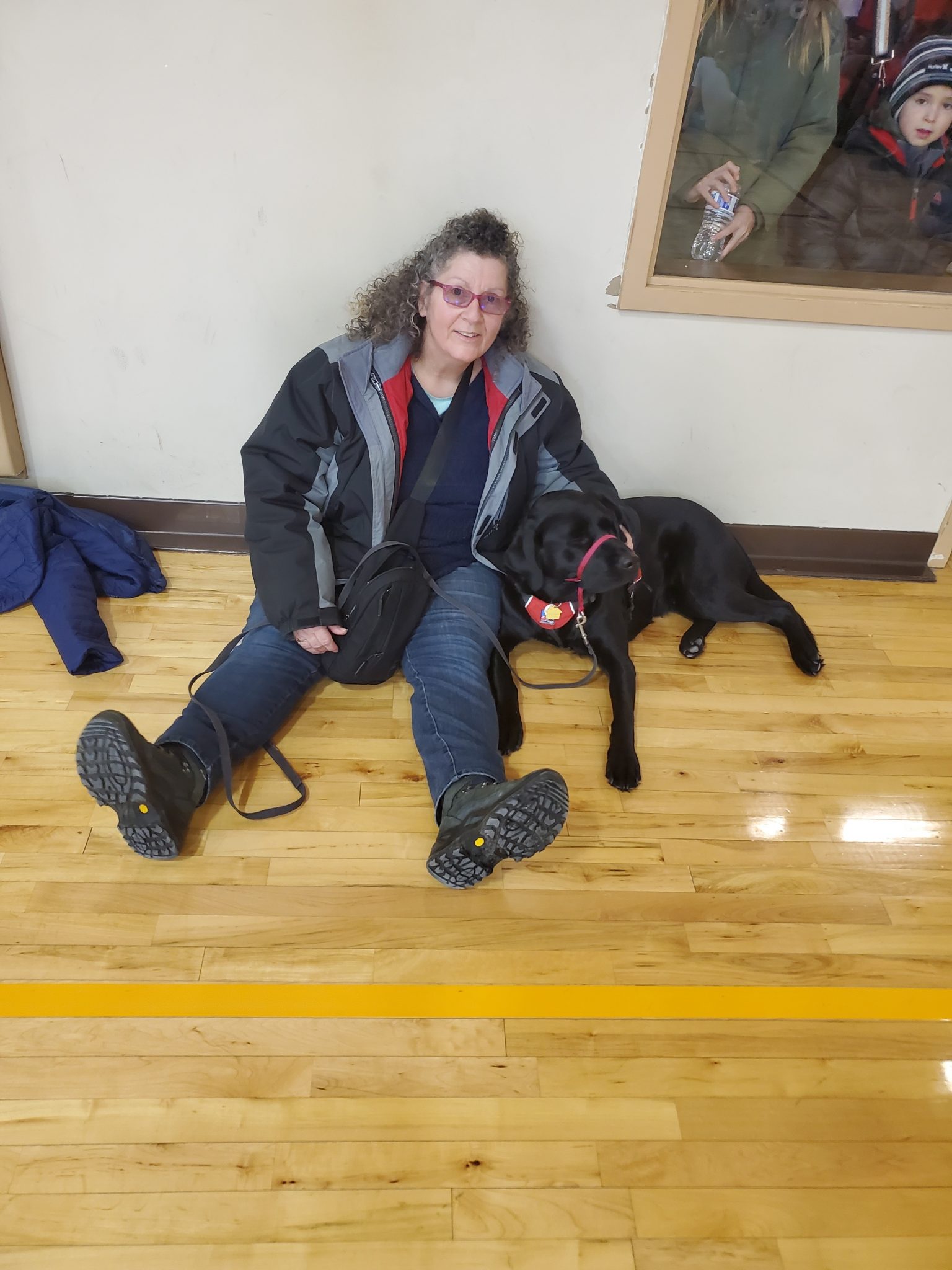 woman and service dog sitting on floor in museum